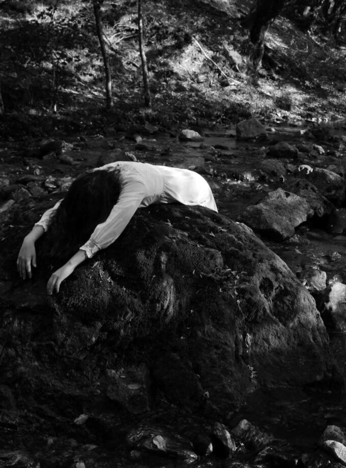 <img src=“Mariam Ambroladze’s photo Dedicated to the place only I see”alt=Black and white” title=“girl laying over a big stone in nature”