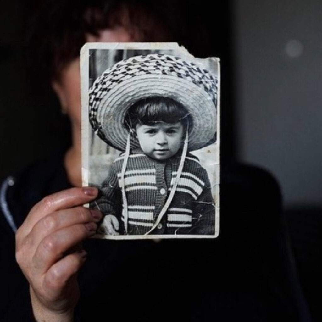 Resident of sanatorium Kartli showing her childhood photo